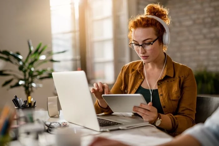 Woman at laptop with tablet
